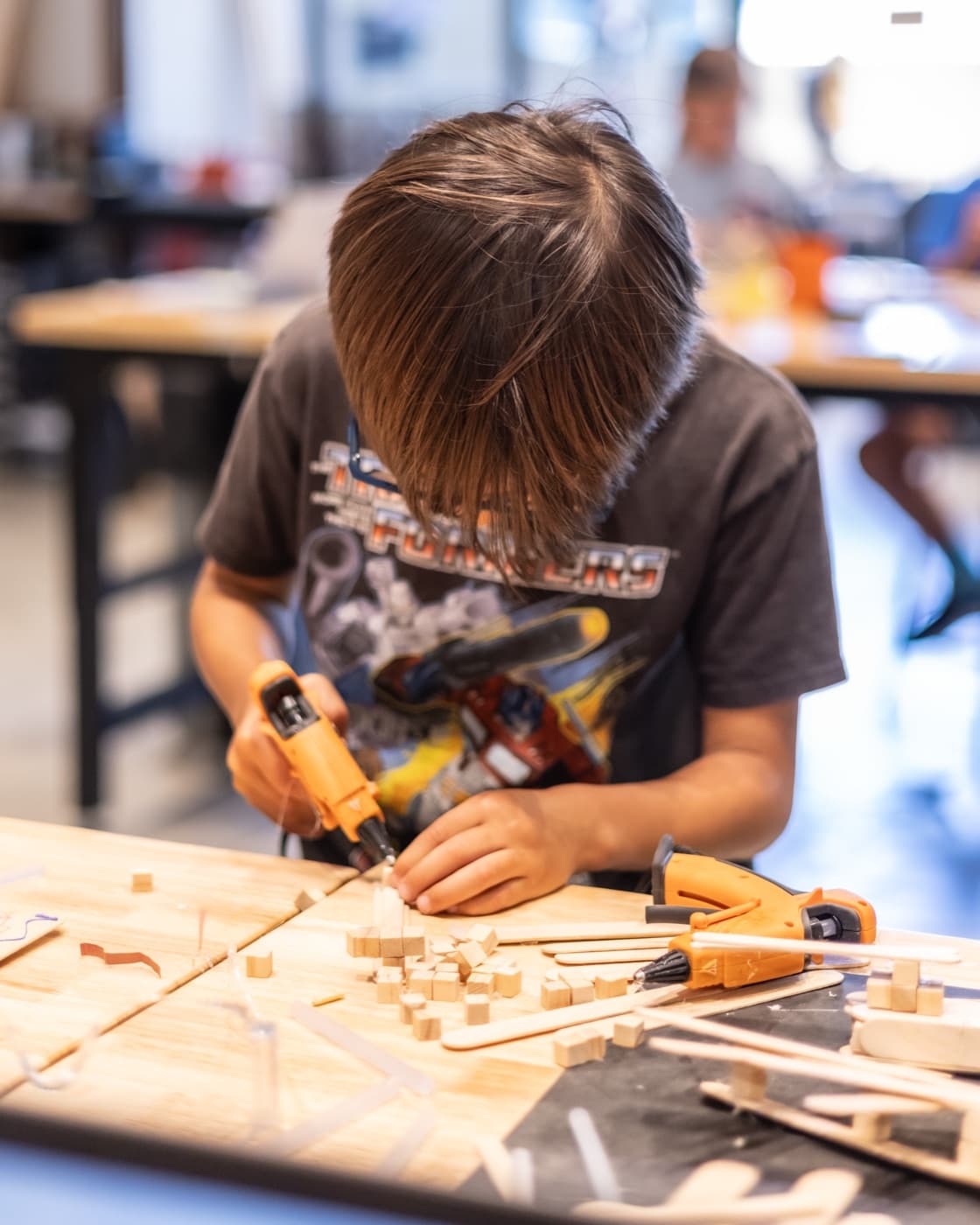 A student working through a build on their own at the bench.