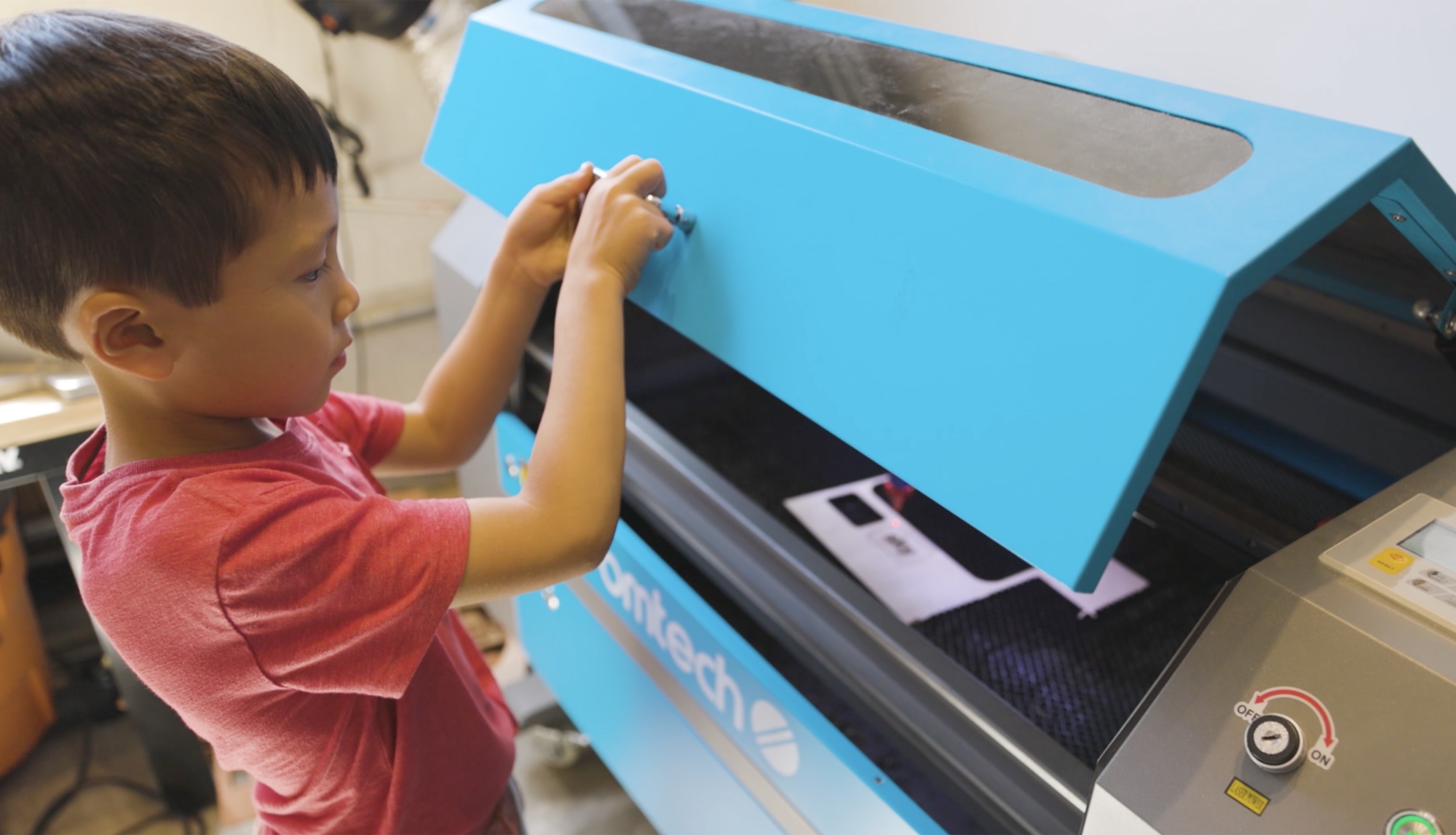 A laser cutter at work in the Forge makerspace