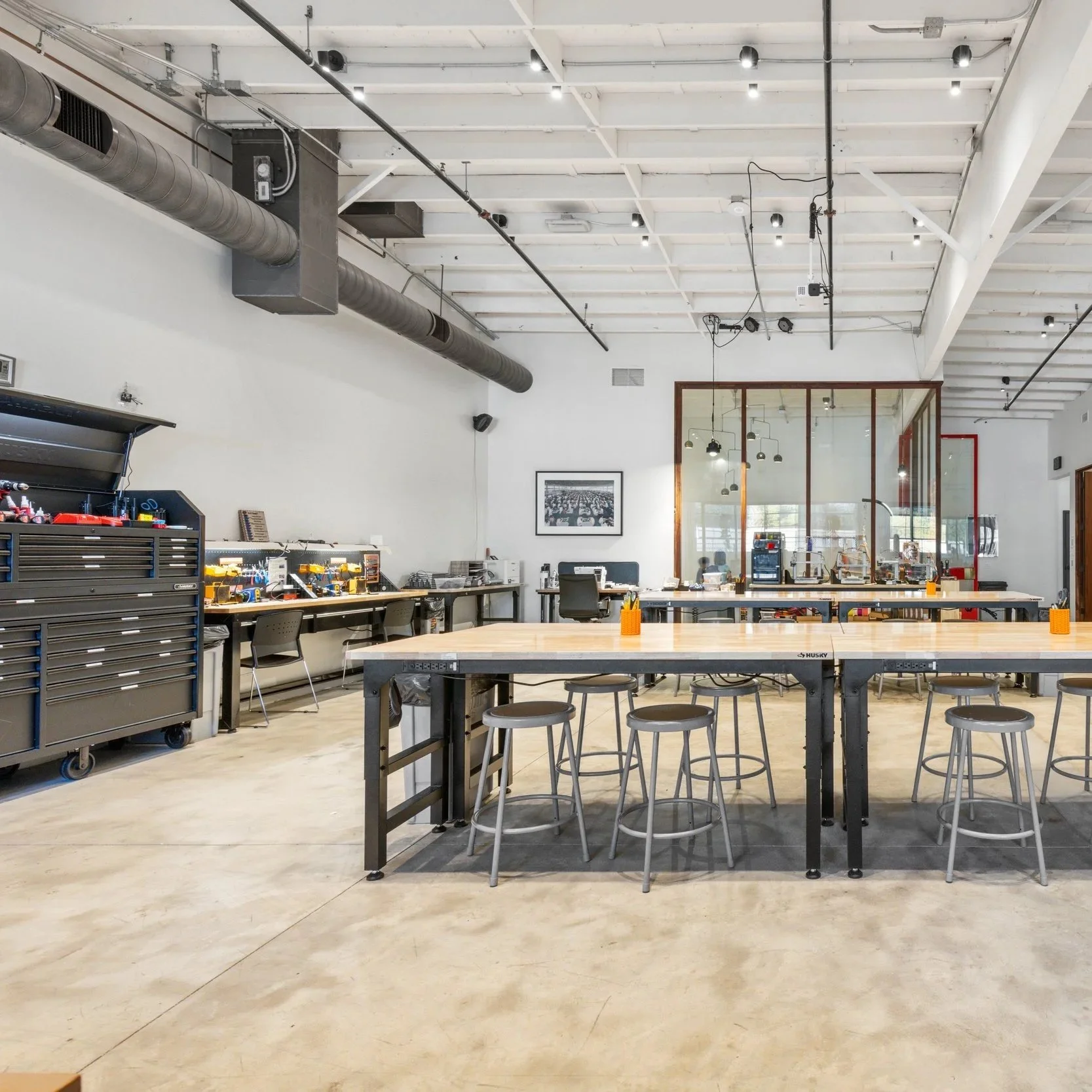 The Forge Makerspace workshop floor with benches and stools.